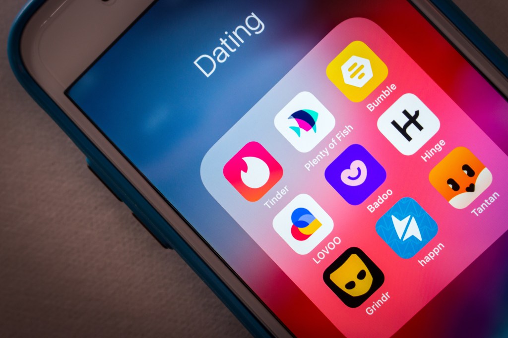 Close-up of popular dating apps Tinder, Plenty of Fish, Bumble, LOVOO, Badoo, Hinge, Grindr, Happn and Tantan on an iPhone screen in a low-light environment