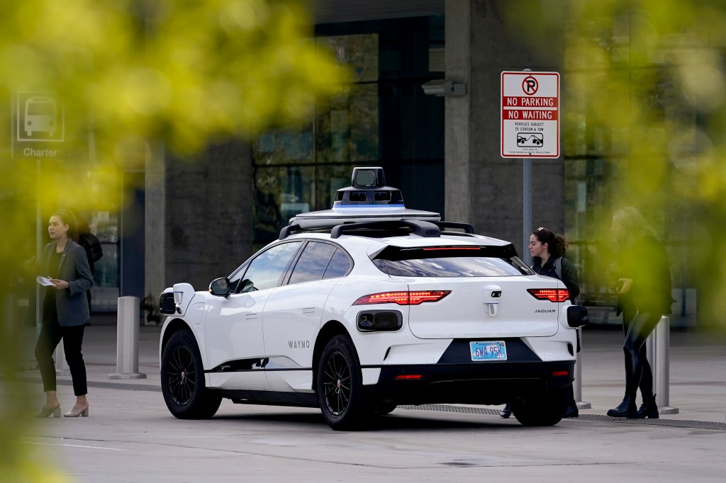 Waymo self-stiring vehicle sits at the expense.