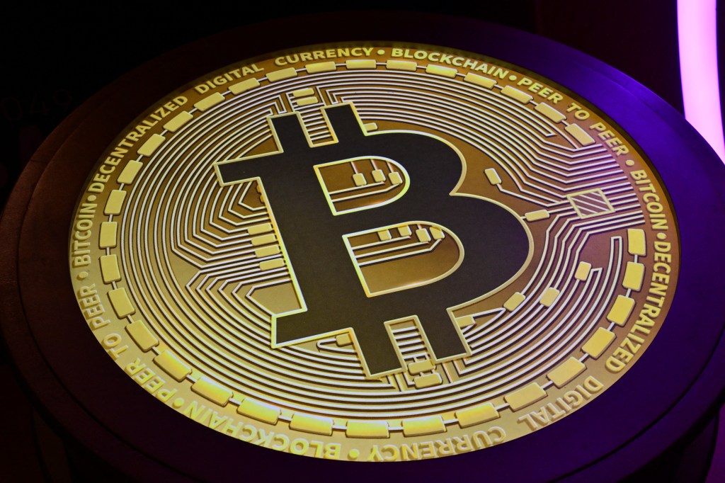 Bitcoin logo appears during the Token Conference.