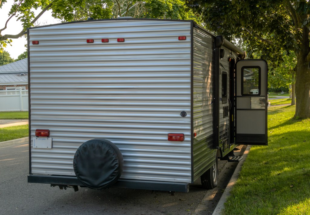 Camping trailer parked on the street.